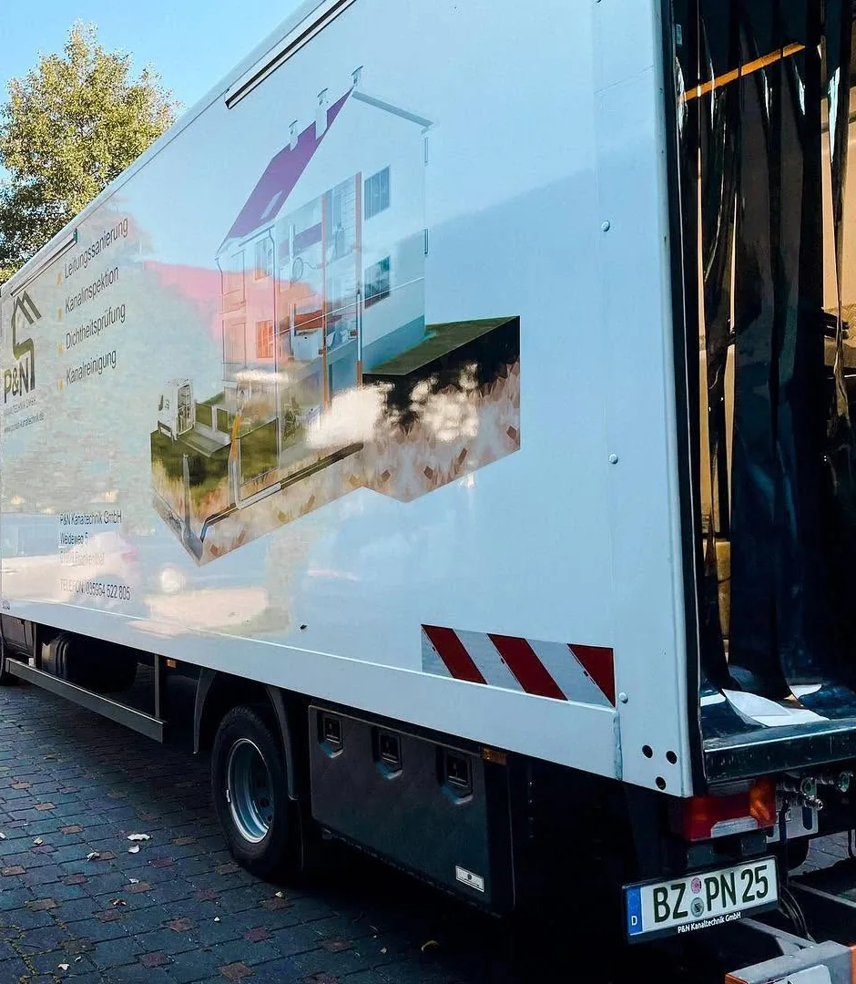 Sanierungs-Lkw der P&N Kanaltechnik GmbH in einer Hofeinfahrt